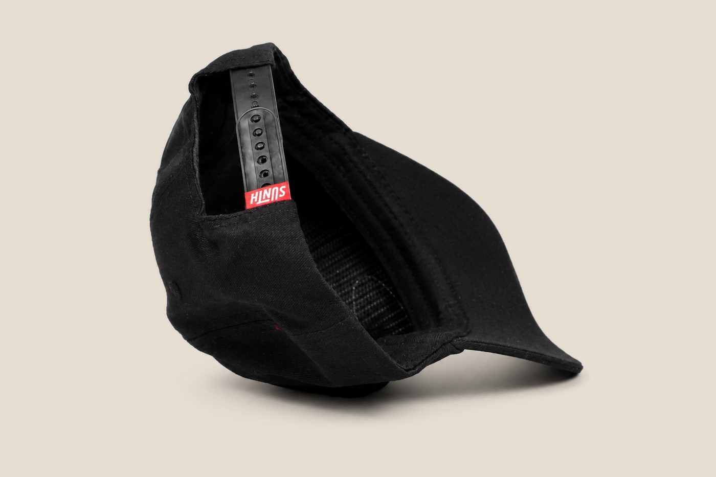 Black Sunth patch cap folded to show the snapback