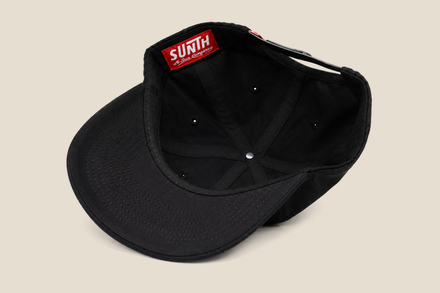 Black Sunth patch cap, interior with woven label