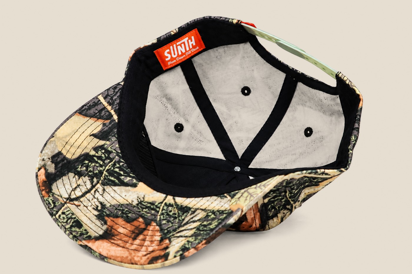 Inside of a camo cap showing taping and labels