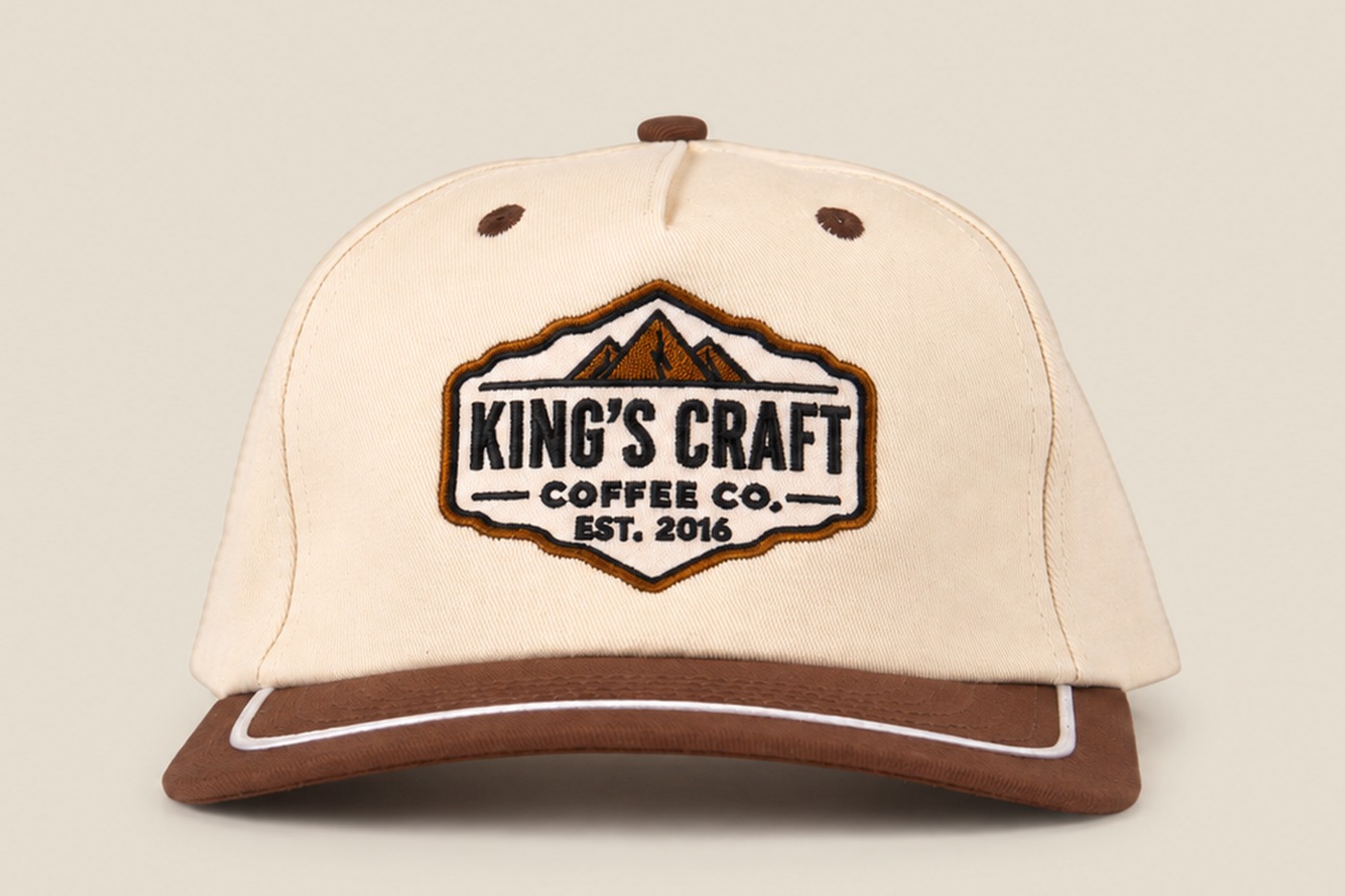 Tan and brown King's Craft Coffee rope cap with mountain patch, front view