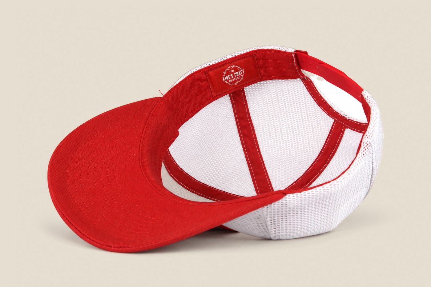 White mesh King's Craft Coffee trucker cap, interior with red taping